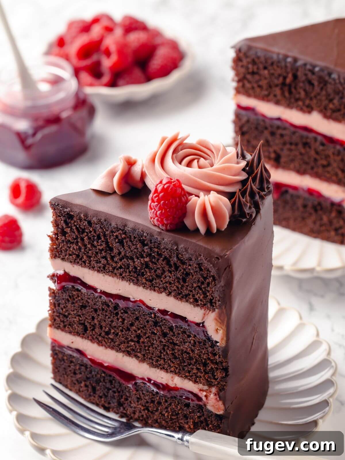 Decadent Chocolate Raspberry Indulgence 2 A single slice of chocolate raspberry cake showing the distinct layers of moist chocolate cake, bright pink raspberry buttercream, and rich chocolate fudge frosting, garnished with a fresh raspberry.