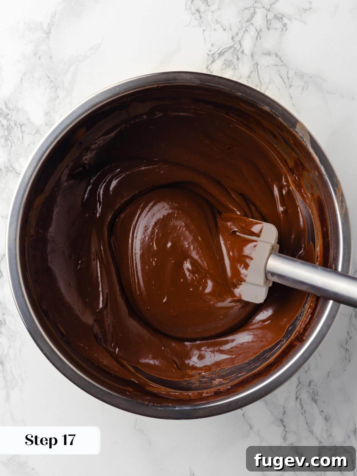 Decadent Chocolate Raspberry Indulgence 20 A bowl of silky, glossy chocolate ganache, perfectly emulsified and cooled to the ideal consistency, ready for frosting.