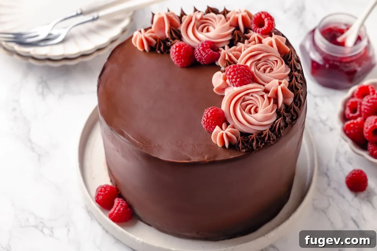 Decadent Chocolate Raspberry Indulgence 3 A whole chocolate raspberry cake adorned with delicate pink raspberry buttercream swirls and fresh raspberries, prepared for serving.