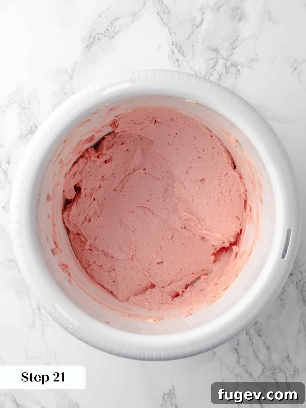 Decadent Chocolate Raspberry Indulgence 22 A bowl of vibrant pink raspberry buttercream frosting, swirled to show its creamy texture, ready to be piped onto the cake.