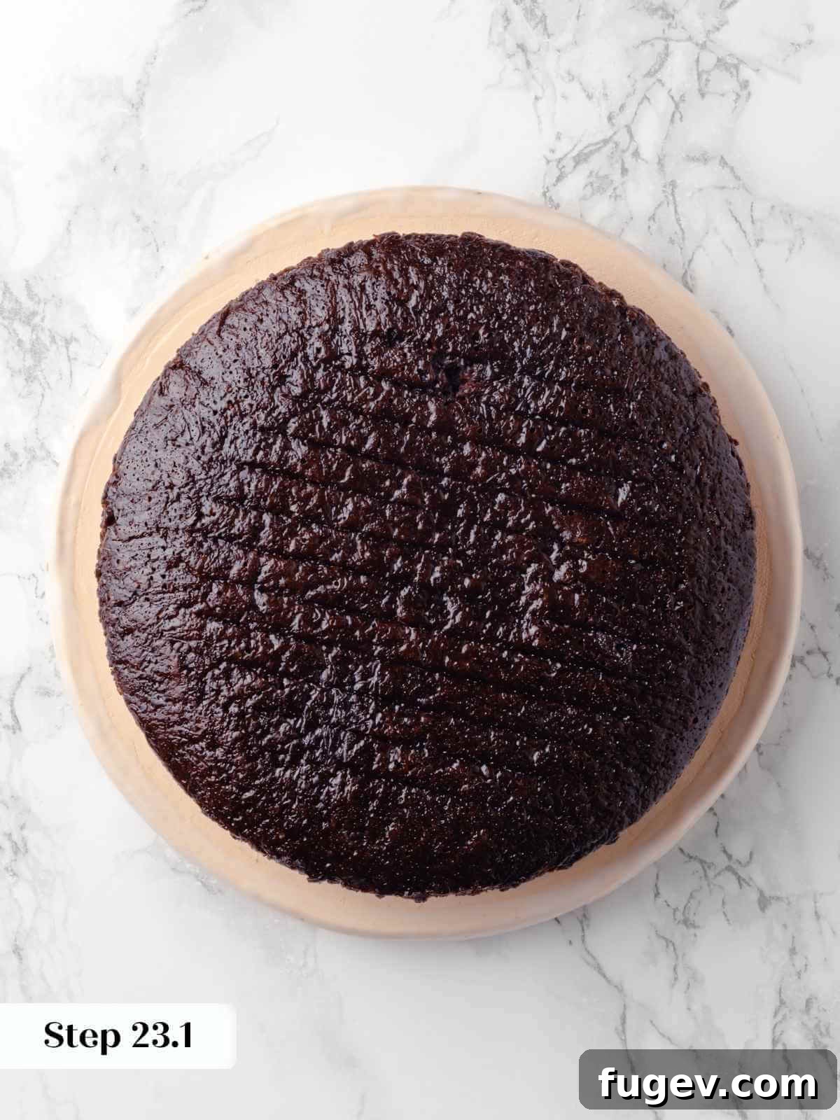 Decadent Chocolate Raspberry Indulgence 23 The first dark chocolate cake layer placed on a cake stand, waiting to be frosted and layered.