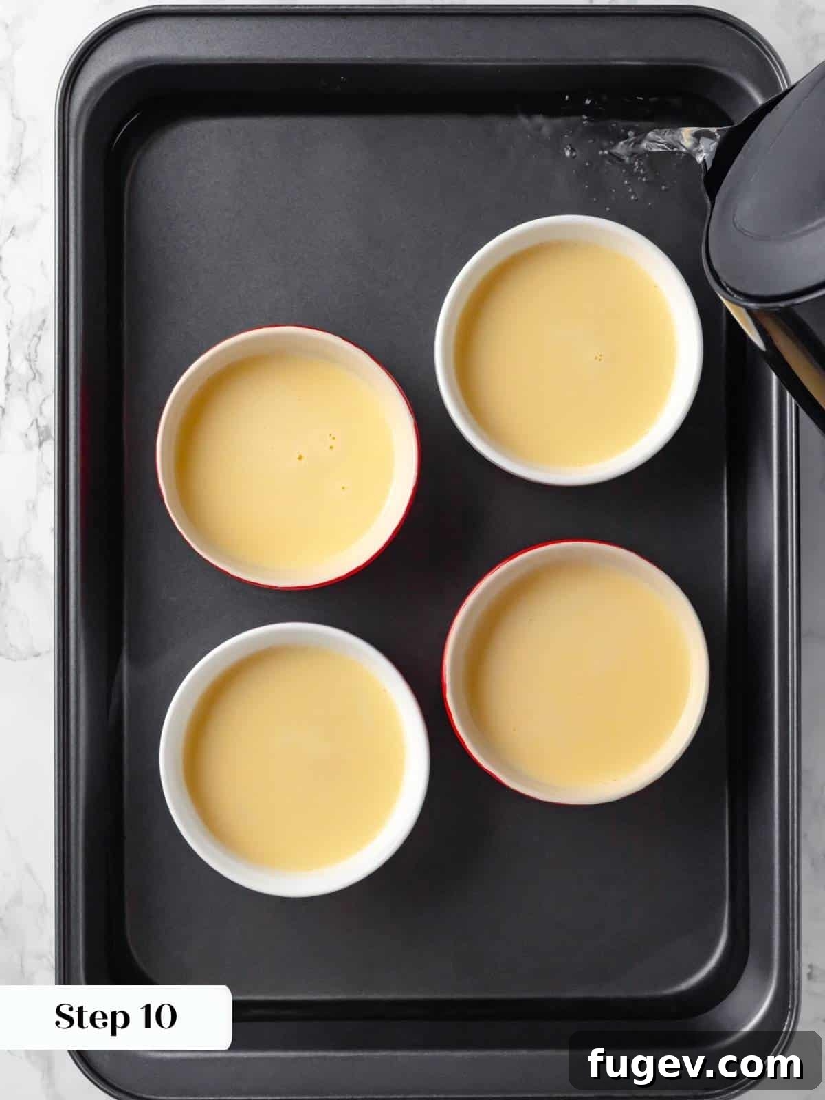 Silky Caramel Custard 14 Hot water being carefully added to a baking pan, creating a water bath for the gentle baking of crème caramel.