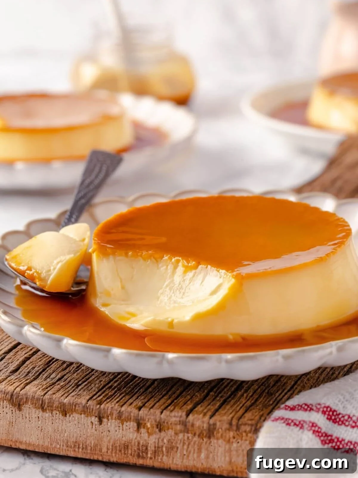 Silky Caramel Custard 17 A single serving of crème caramel with a silver spoon poised, ready to delve into its creamy texture and rich caramel.