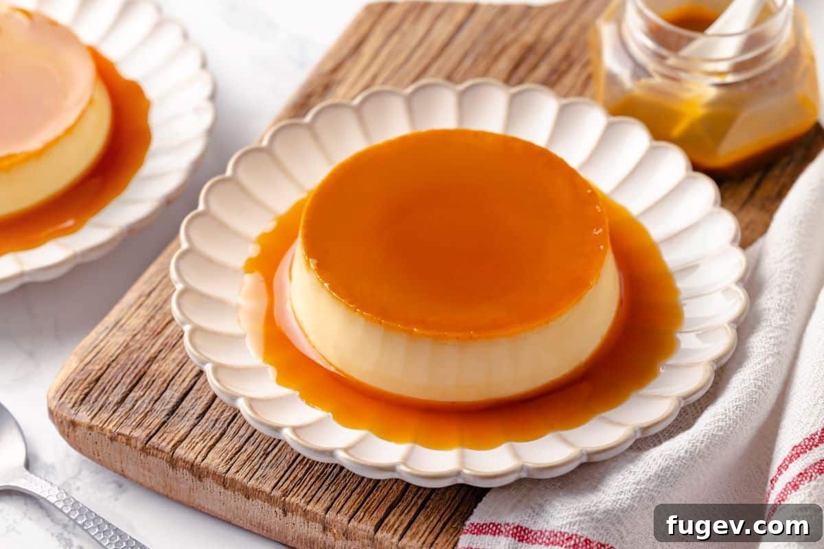 Silky Caramel Custard 4 A beautifully plated creme caramel dessert served with its glossy caramel sauce pooling around it on a white plate, ready to be enjoyed.