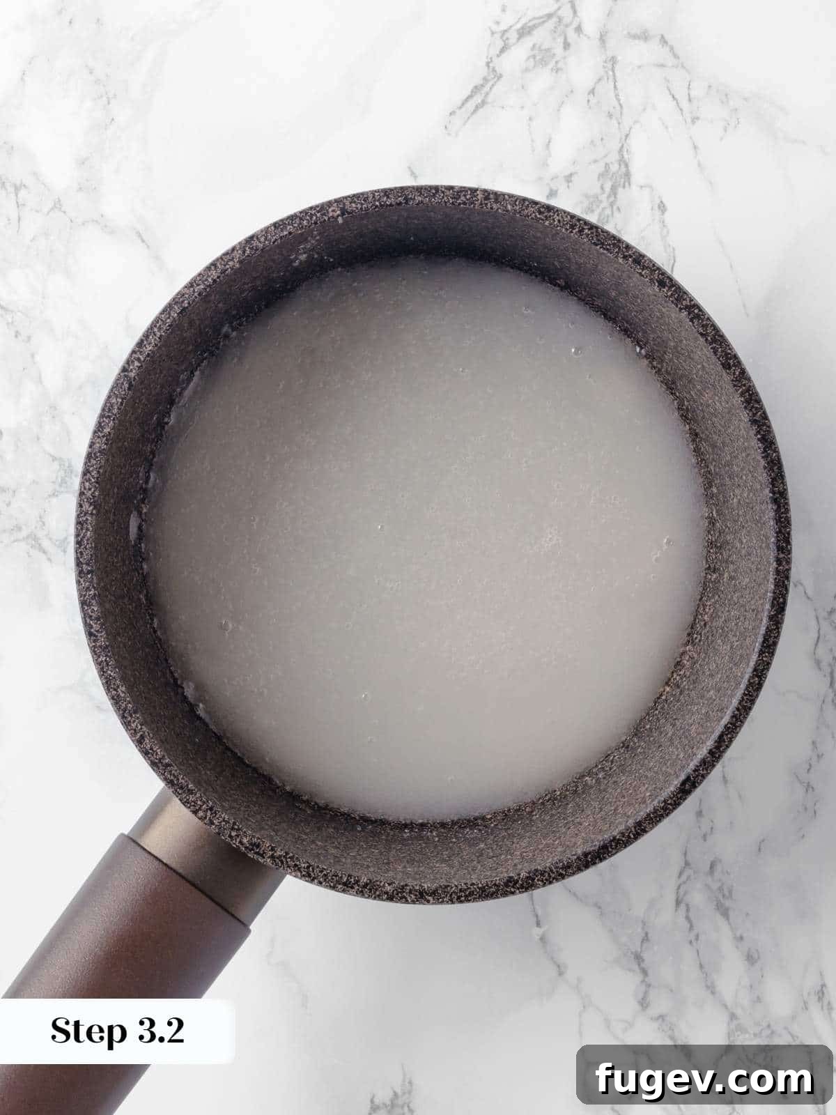 Silky Caramel Custard 6 Water added to melted sugar in a pan, beginning the wet caramel process for creme caramel.