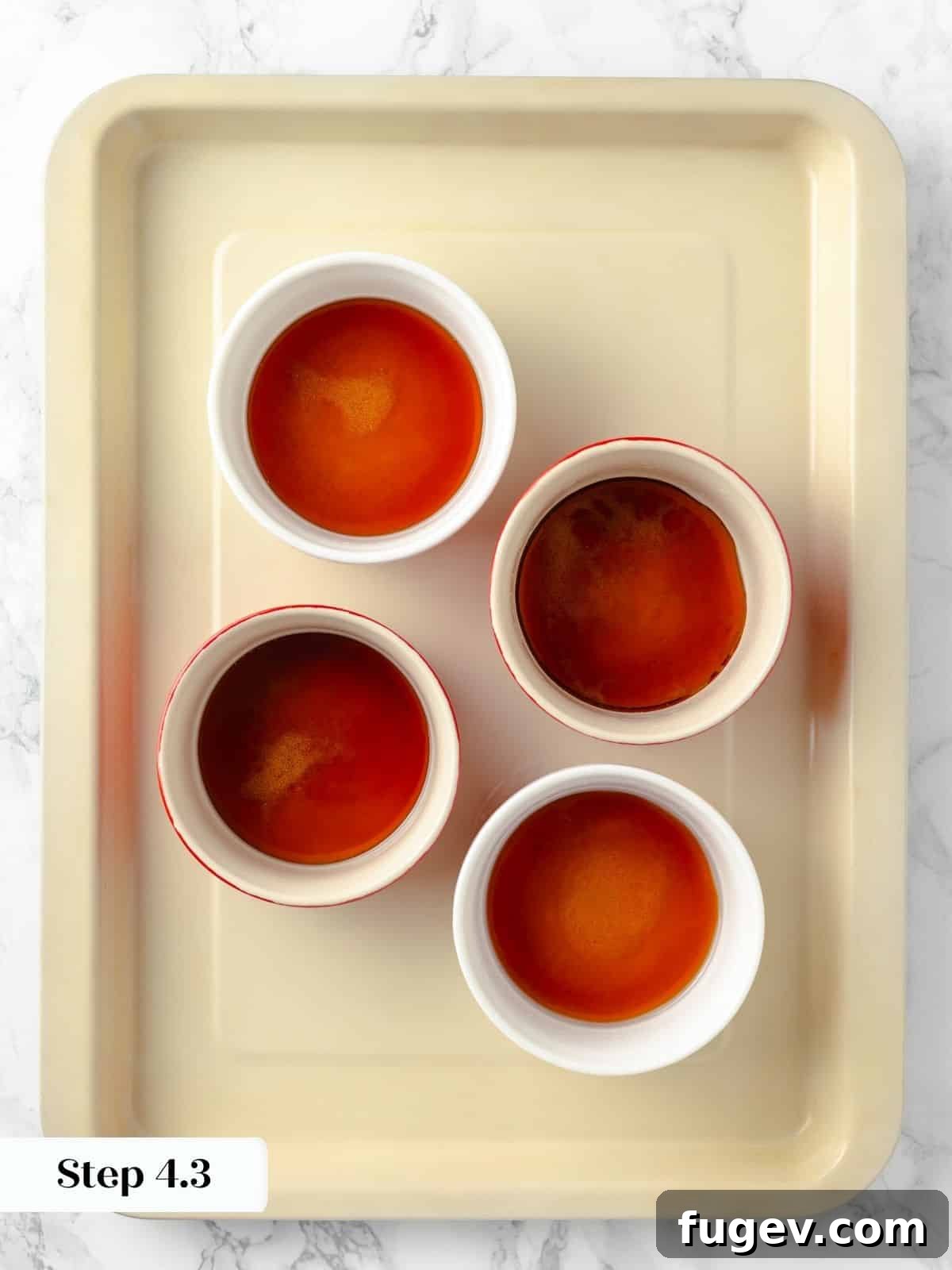 Silky Caramel Custard 9 Ramekins filled with a glossy layer of caramelized sugar, perfectly set and awaiting the custard.