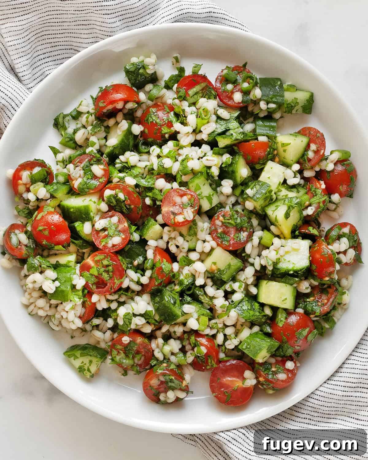 Wholesome Barley Tabbouleh 2 A vibrant bowl of Pearl Barley Tabbouleh Salad, showcasing fresh herbs, colorful tomatoes, and the wholesome grain.