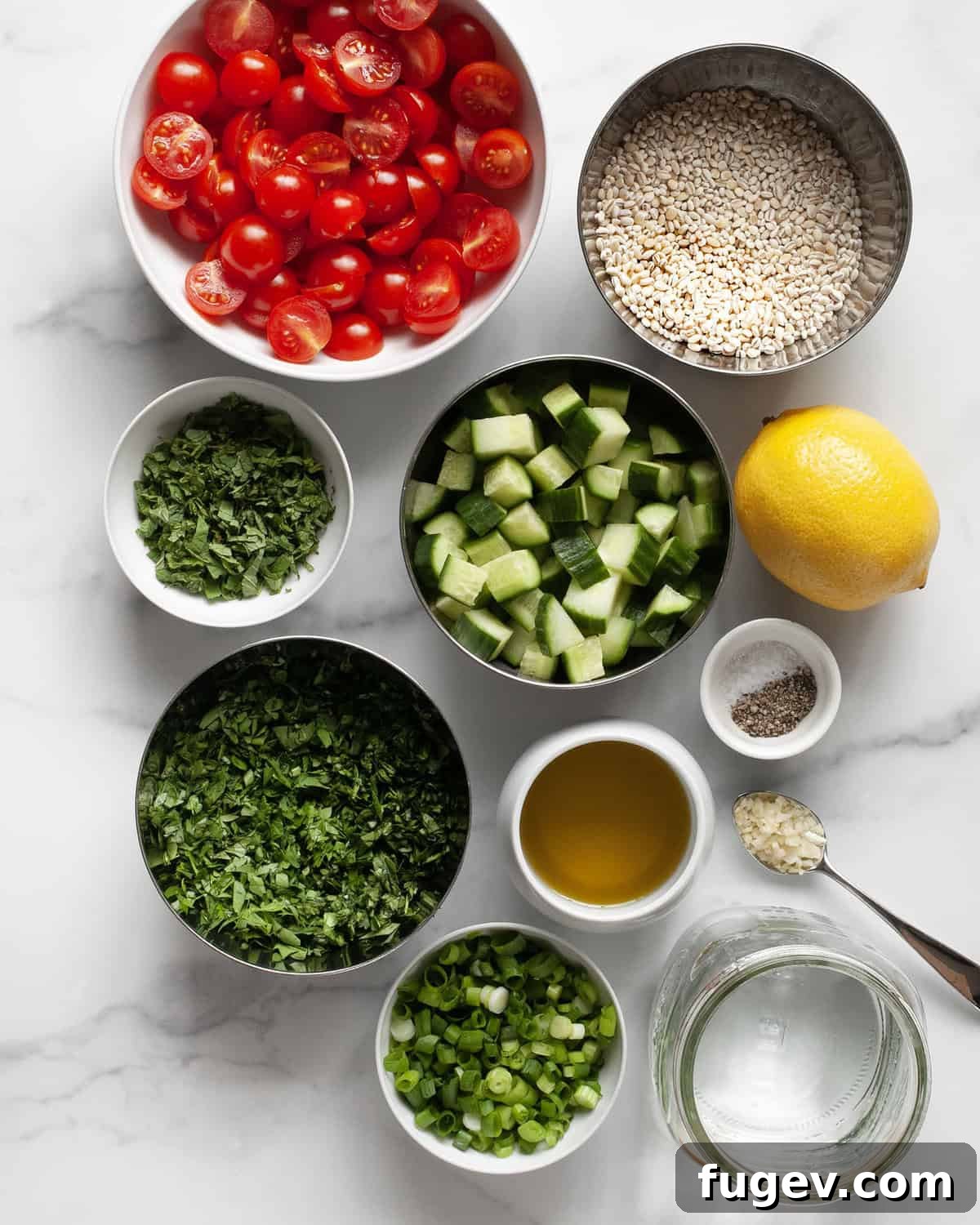 Wholesome Barley Tabbouleh 3 A colorful array of fresh ingredients laid out, including vibrant parsley, mint, lemons, olive oil, cherry tomatoes, crisp cucumbers, scallions, garlic, and pearl barley, ready for making tabbouleh.