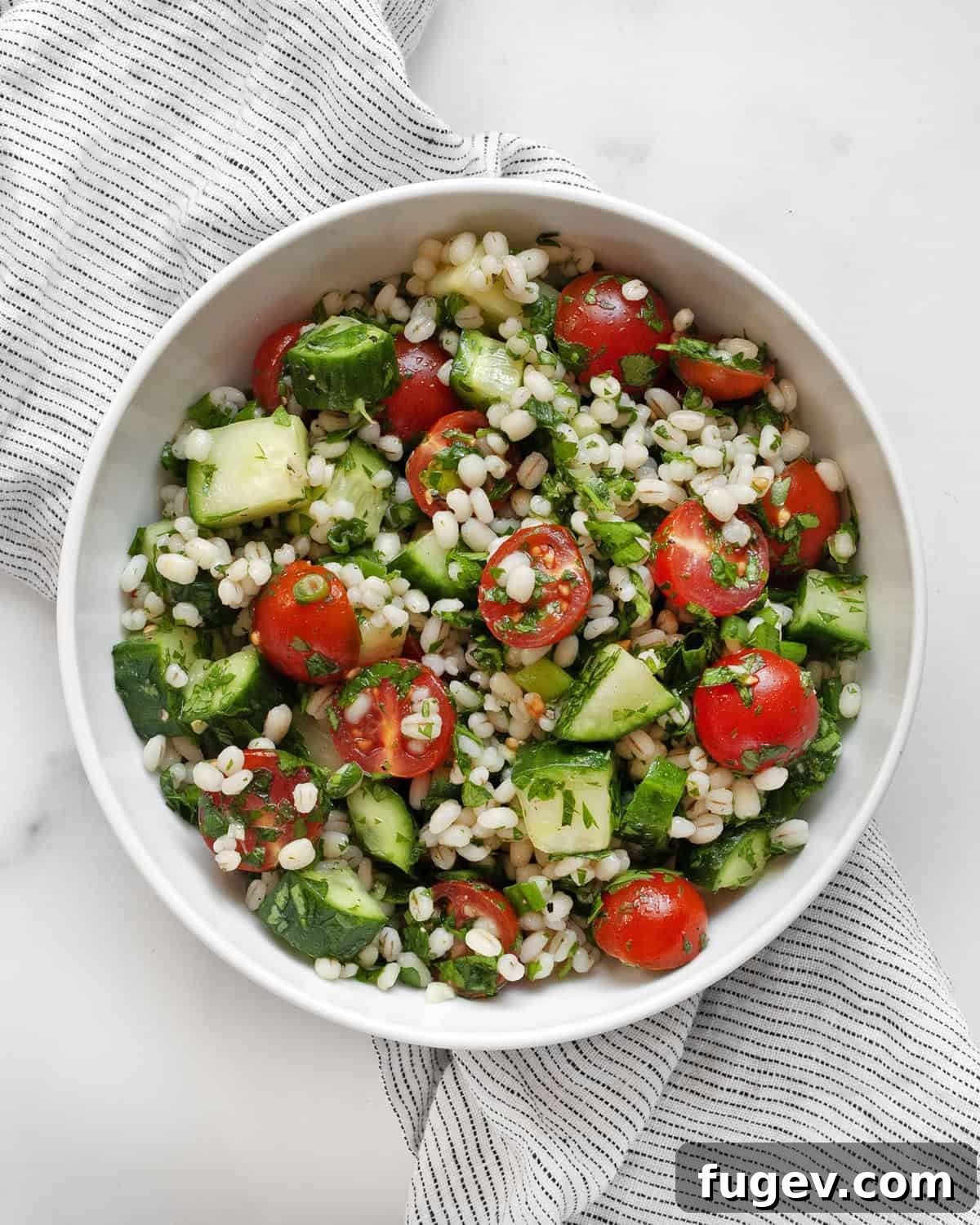 Wholesome Barley Tabbouleh 6 A small, elegant bowl filled with vibrant Pearl Barley Tabbouleh Salad, ready to be enjoyed.