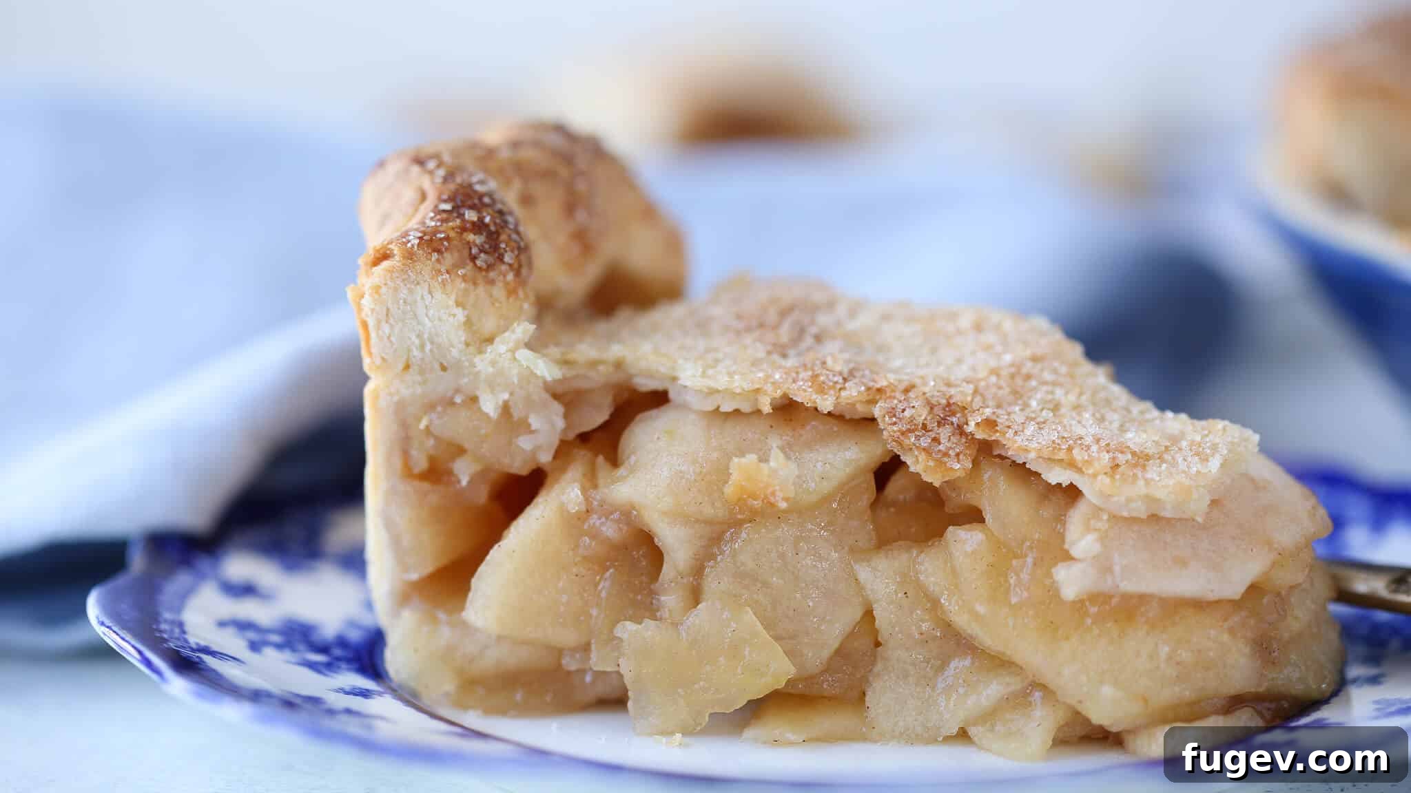 Epic Apple Pie 4 A side view of the Mile High Apple Pie, showing off its impressive height and golden-brown, flaky crust.