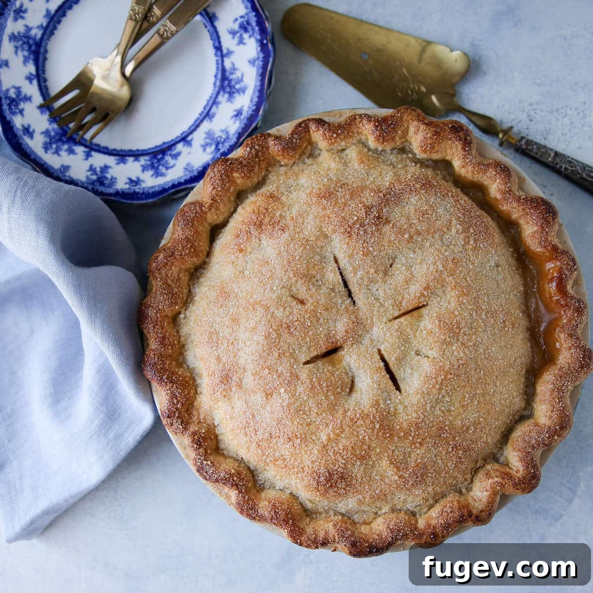 Epic Apple Pie 6 The Mile High Apple Pie, freshly baked and ready for slicing, sitting elegantly on a cooling rack.