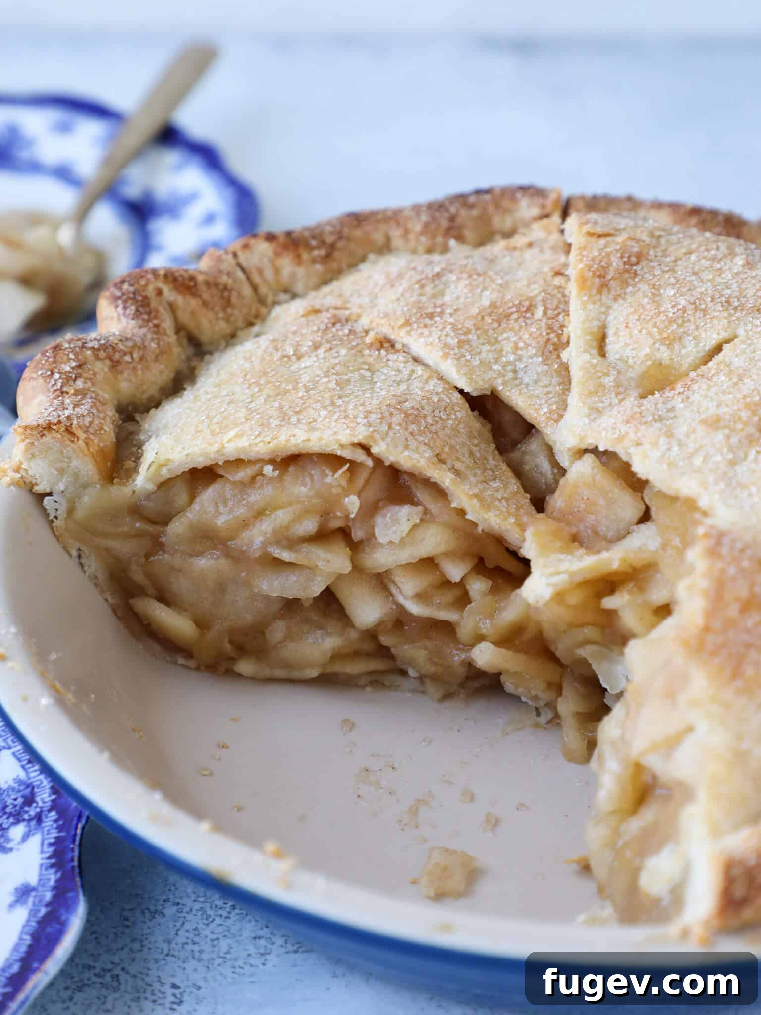Epic Apple Pie 7 A stunning interior view of a sliced Mile High Apple Pie, showcasing the dense, perfectly cooked apple filling and flaky crust.