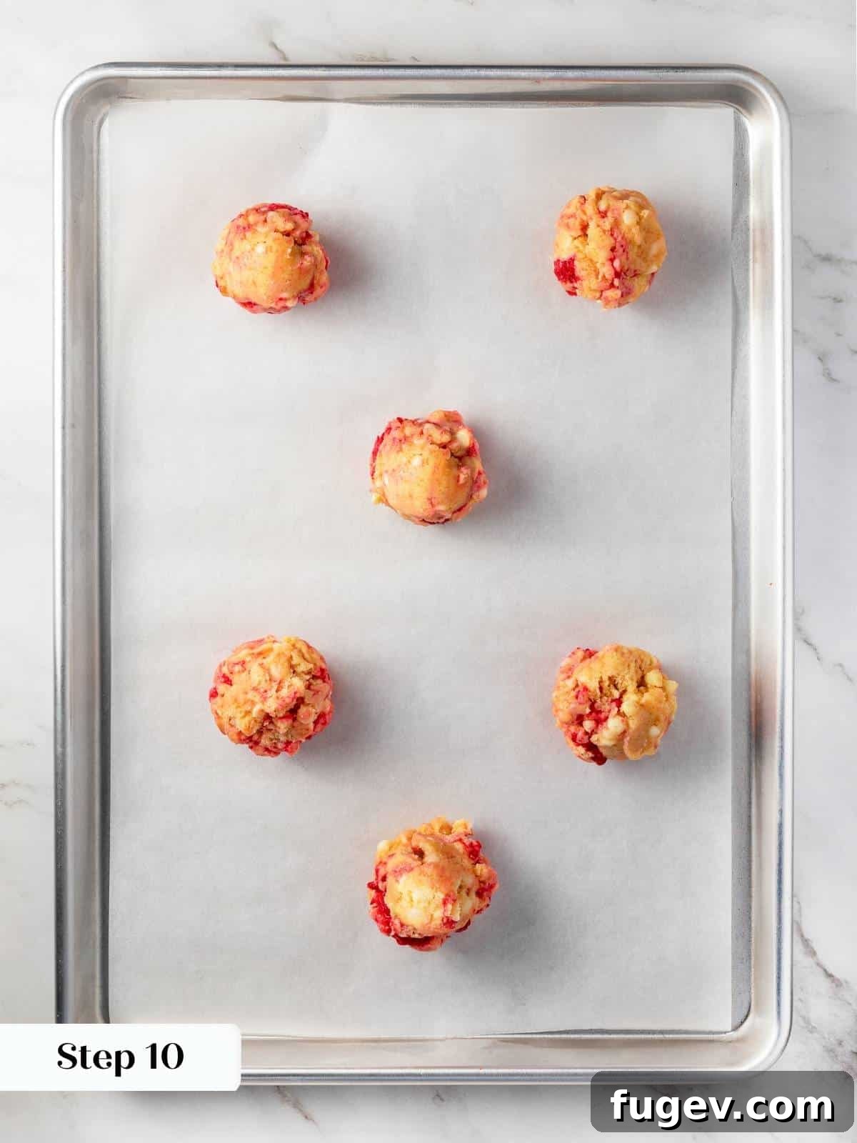 Velvet White Chocolate Raspberry Cookies 14 Uniformly portioned cookie dough balls, scooped onto a parchment-lined baking sheet, spaced perfectly apart and ready for the oven.
