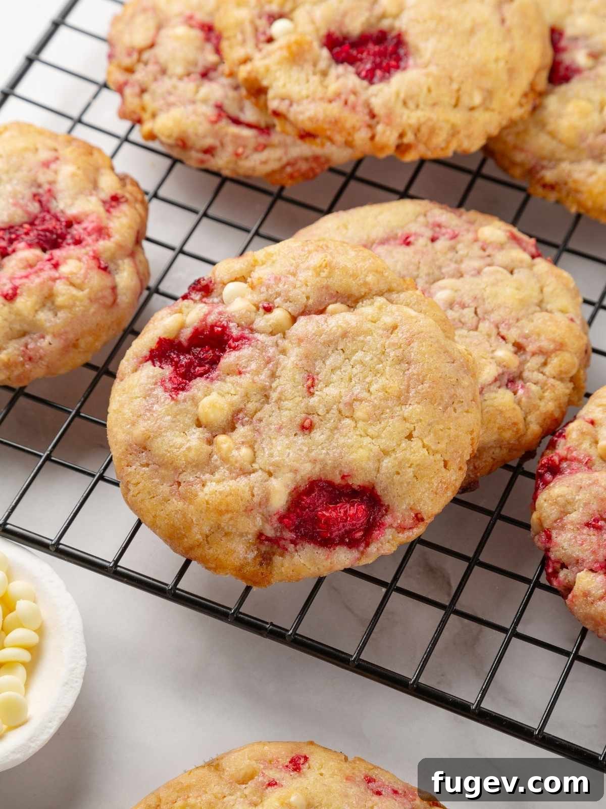 Velvet White Chocolate Raspberry Cookies 16 Delicious white chocolate raspberry cookies cooling gracefully on a wire rack, achieving their perfect chewy texture.