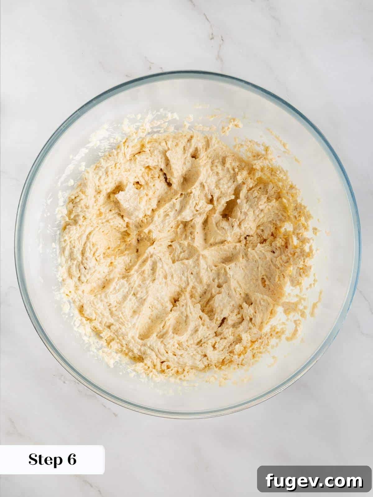Velvet White Chocolate Raspberry Cookies 7 Cookie dough in a mixer, showing eggs and vanilla extract being incorporated, creating a rich and fragrant base.