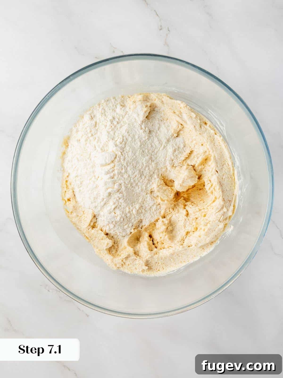 Velvet White Chocolate Raspberry Cookies 8 Flour mixture being slowly and carefully added to the wet ingredients in a mixer, forming the cohesive cookie dough.