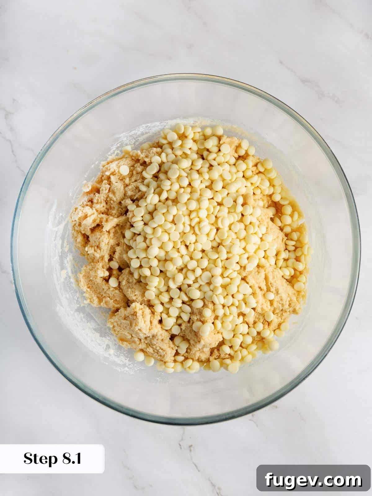 Velvet White Chocolate Raspberry Cookies 10 High-quality white chocolate chips being added to the rich cookie dough, promising creamy, sweet pockets in every bite.