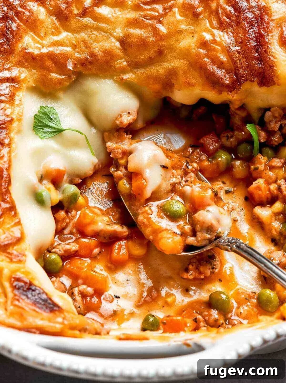Golden Chicken Potato Bake 2 A close-up of the layers of vegetables, chicken, and mashed potatoes inside the shepherd’s pie.