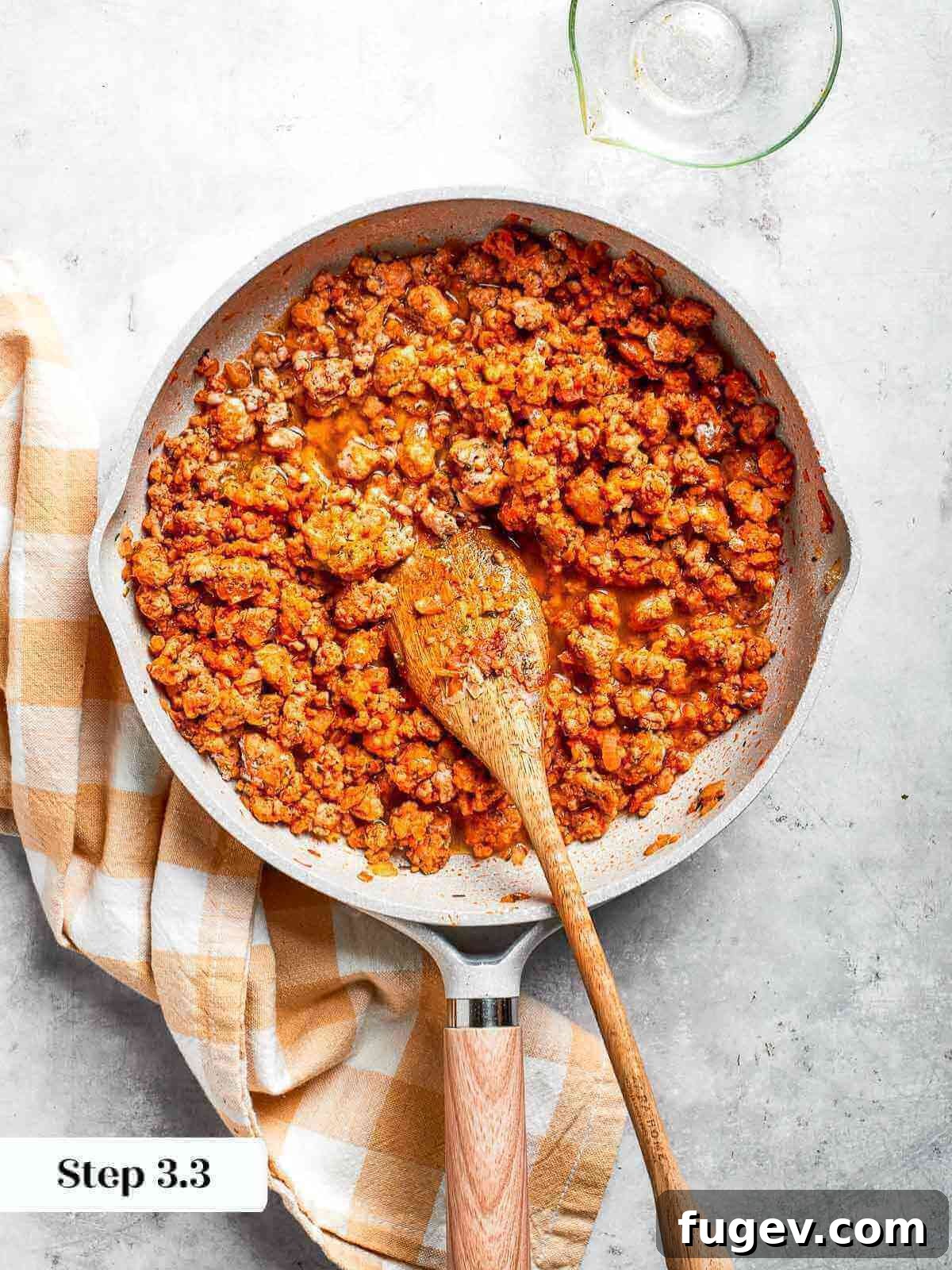 Golden Chicken Potato Bake 12 A pan of fully cooked ground chicken with rich, golden-brown seasoning.