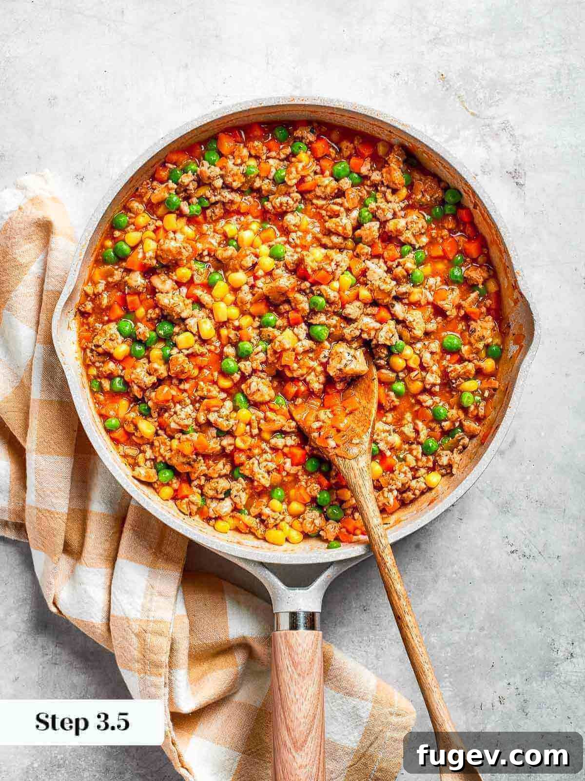Golden Chicken Potato Bake 14 A pan filled with soft, seasoned vegetables, steaming and rich in color.