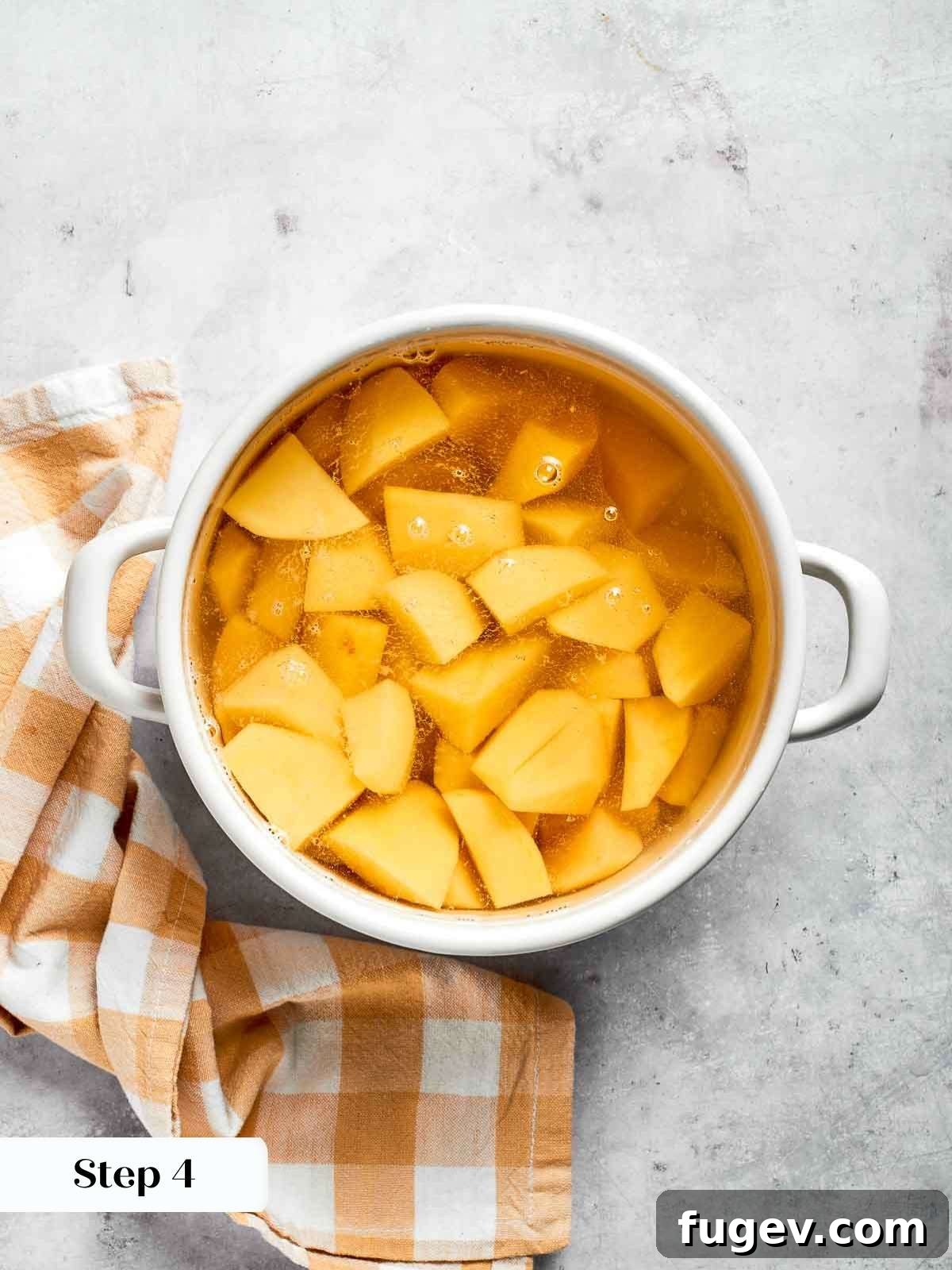 Golden Chicken Potato Bake 15 Steaming potatoes in a pot of hot water, ready to be cooked for the shepherd’s pie topping.