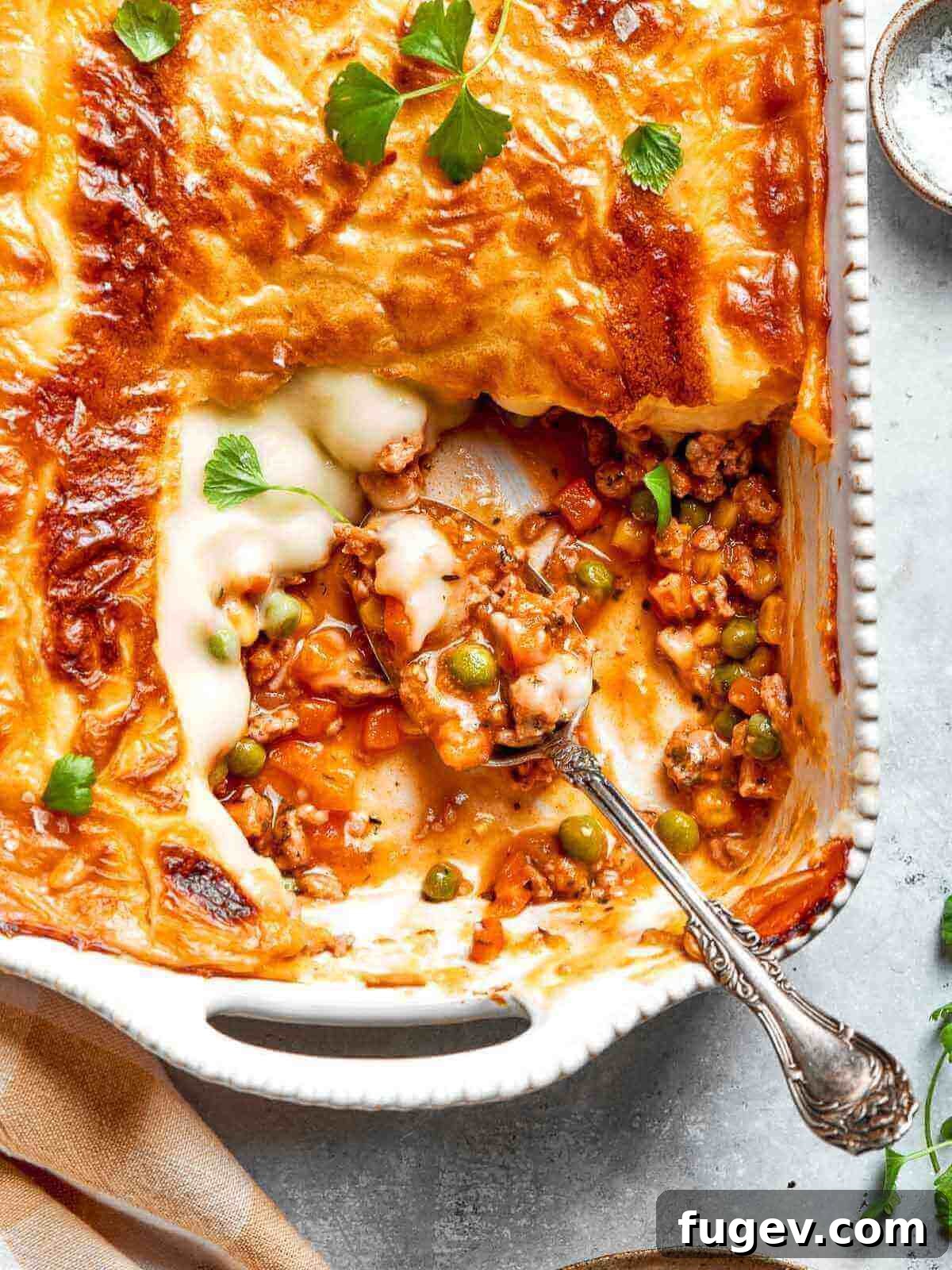Golden Chicken Potato Bake 19 A perfectly baked Chicken Shepherd’s Pie in a white dish, ready to serve.