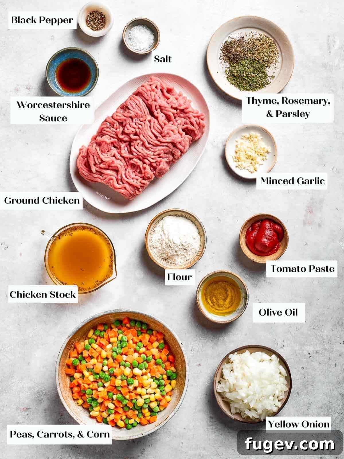 Golden Chicken Potato Bake 5 A full ingredient spread for making Chicken Shepherd’s Pie, showcasing fresh herbs, chicken, seasonings, and more.