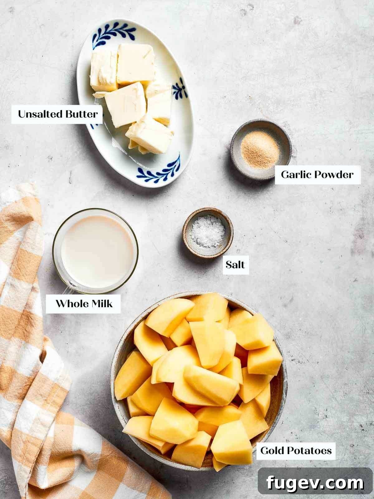 Golden Chicken Potato Bake 6 Ingredients for mashed potatoes prepped and ready, featuring gold potatoes, butter, salt, and milk in small bowls.