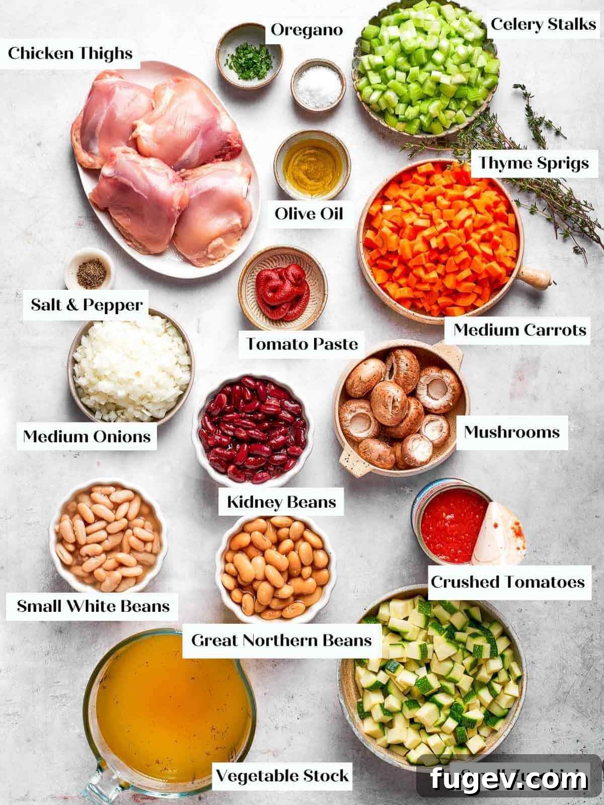 Nourishing Chicken Vegetable Medley 4 All fresh ingredients for chicken vegetable soup arranged beautifully on a white marble countertop.