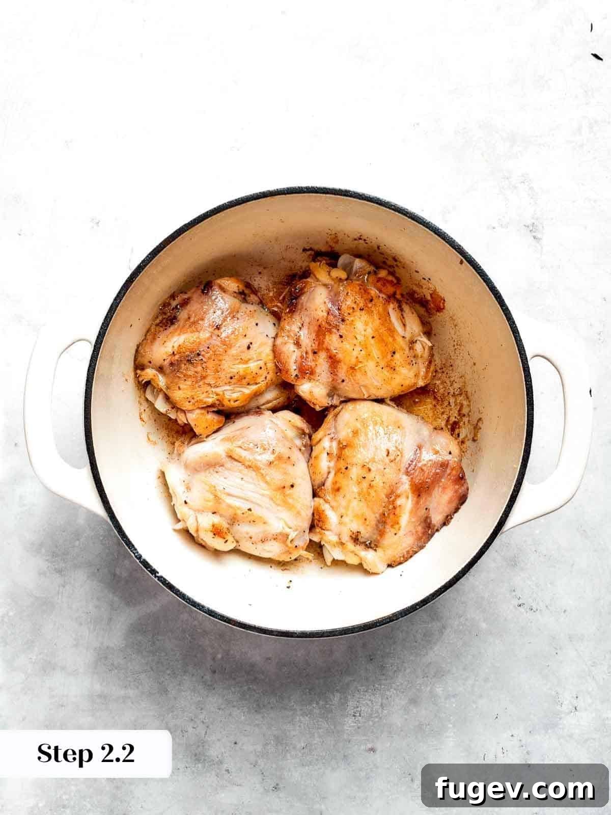 Nourishing Chicken Vegetable Medley 6 Perfectly browned chicken thighs searing in the soup pan, ready to be removed.