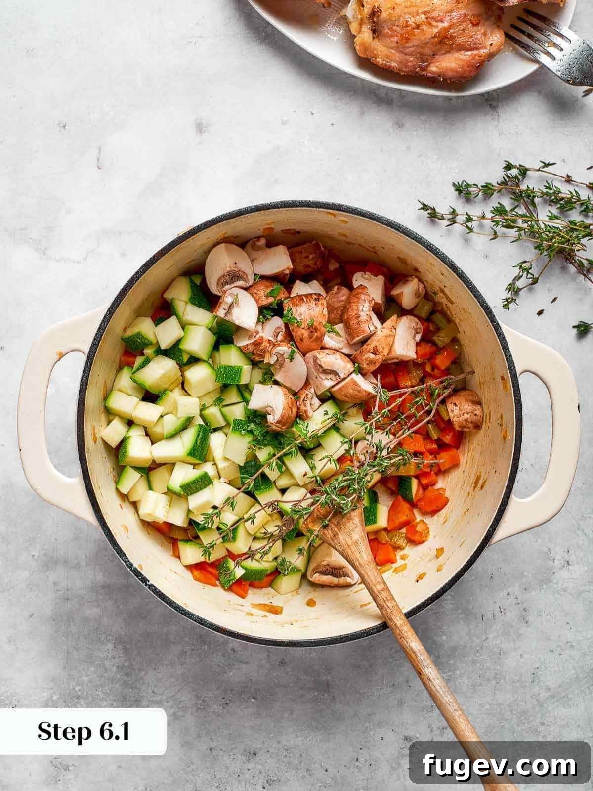 Nourishing Chicken Vegetable Medley 9 Freshly cut zucchini pieces being added to the rich vegetable soup base.
