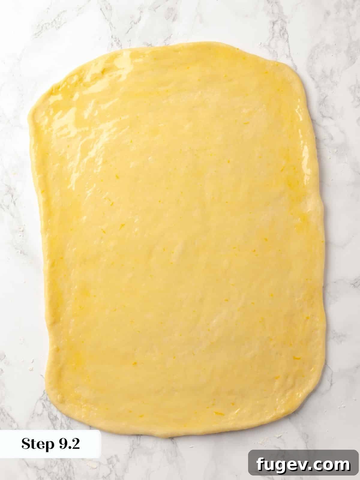Gooey Pecan Caramel Rolls 17 A large sheet of dough brushed with melted butter.