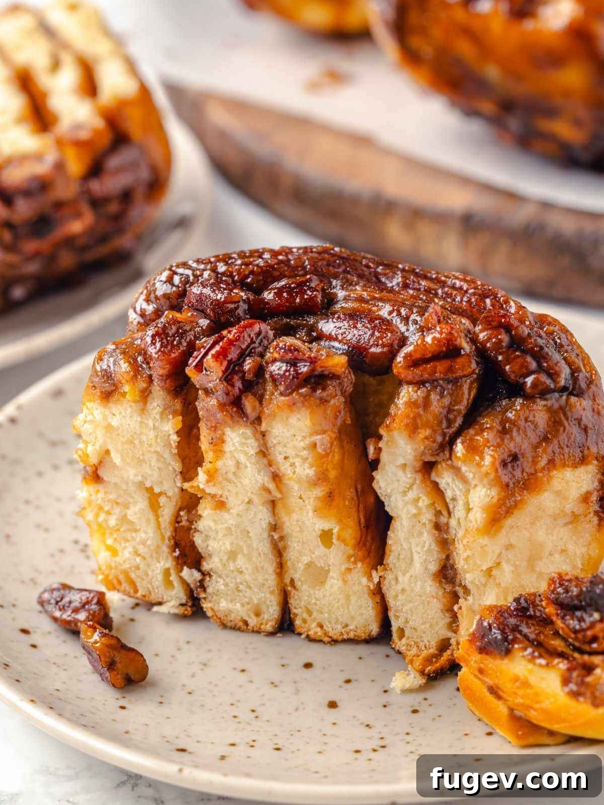 Gooey Pecan Caramel Rolls 25 Gooey pecan sticky buns on a plate, ready to enjoy.