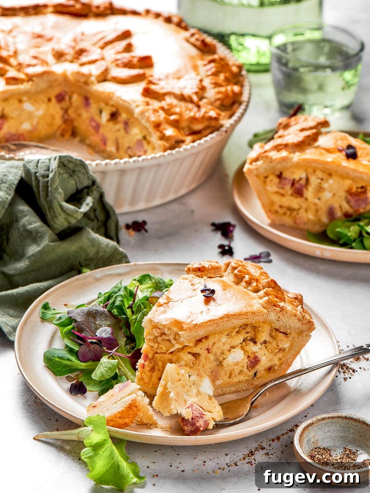 Rustic Italian Easter Pie 2 A neatly cut piece of deep-dish Italian Easter pie, showcasing its golden crust and rich, layered filling of cheese and meats.