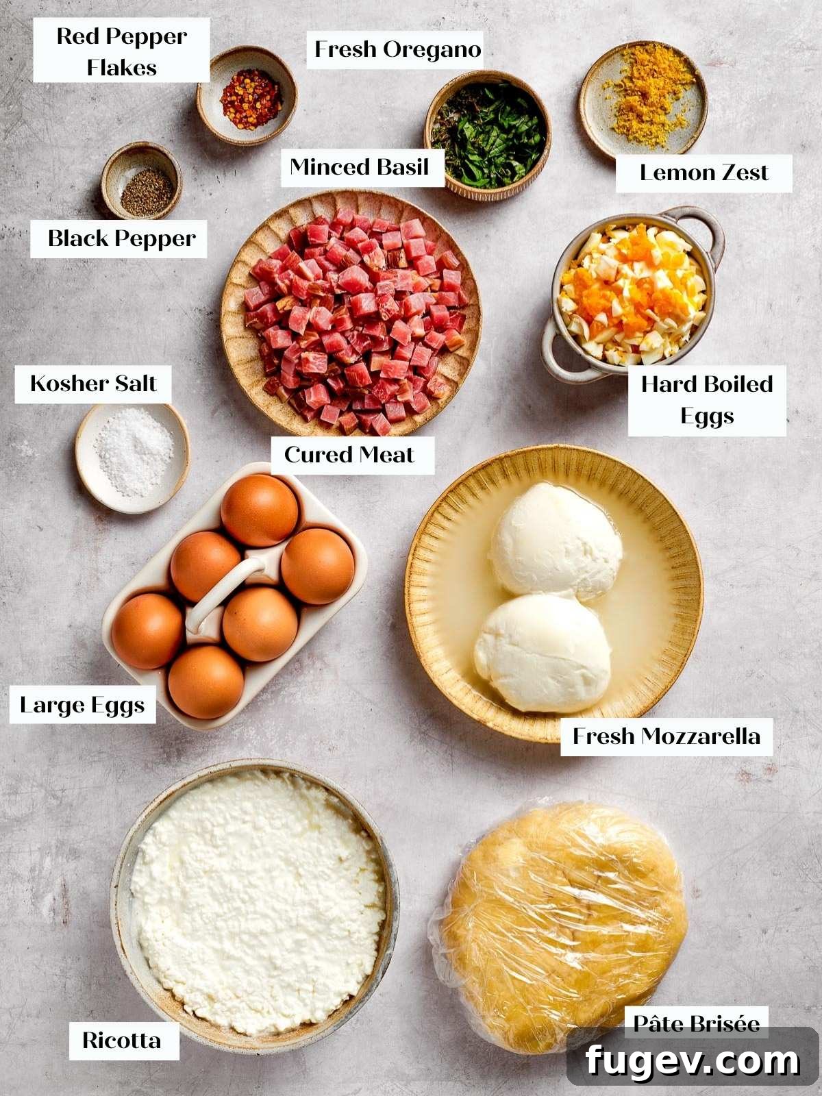 Rustic Italian Easter Pie 3 A vibrant display of fresh ingredients for pizza rustica, including cheeses, cured meats, and herbs, arranged on a kitchen countertop.