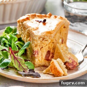 Rustic Italian Easter Pie 17 A beautifully plated slice of Pizza Rustica with a golden, flaky crust and a generous, cheesy filling studded with meats.