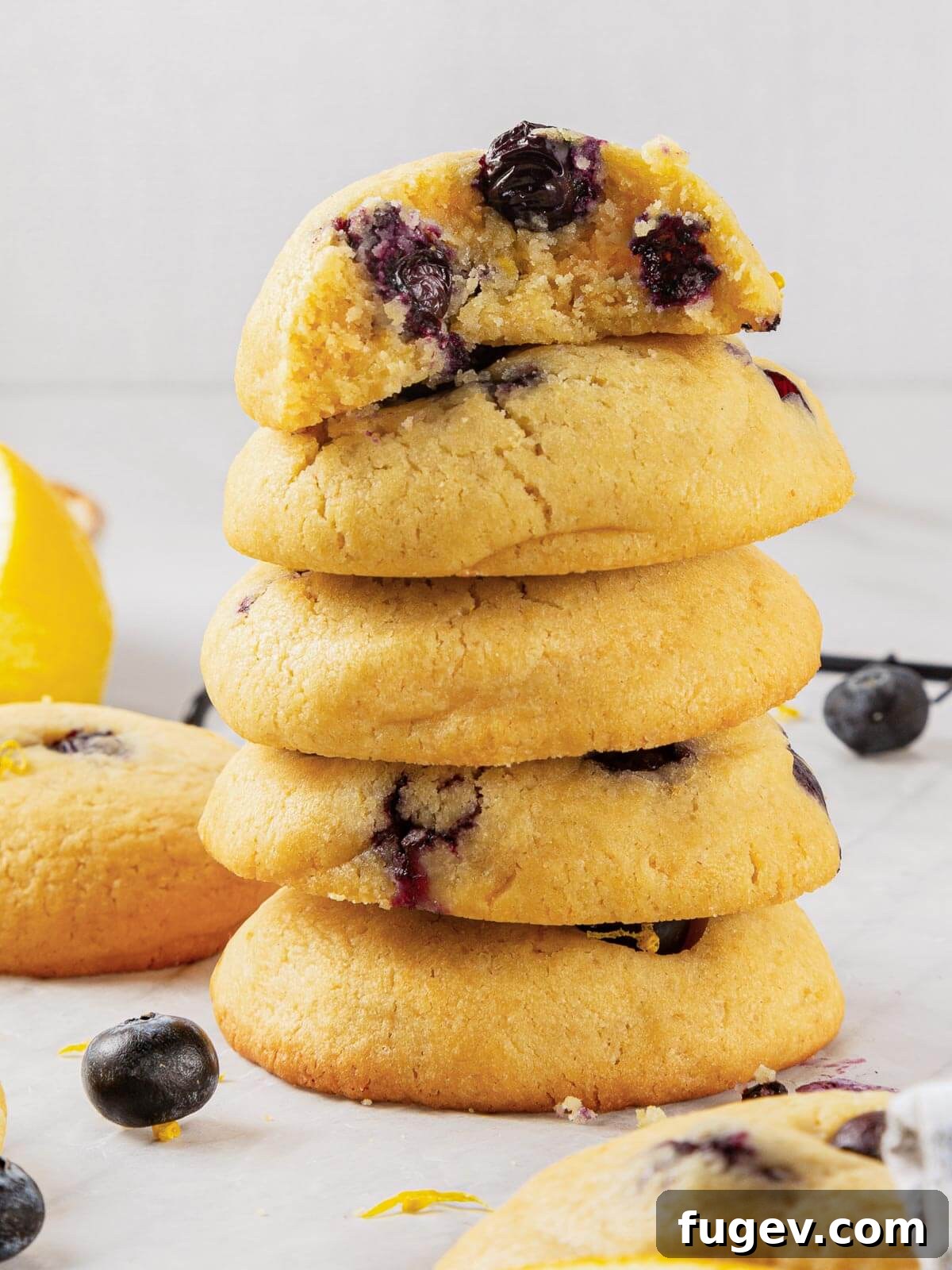Bright Lemon Blueberry Delights 2 A batch of cookies fully cooled and ready to eat, showcasing their golden edges and plump blueberries.