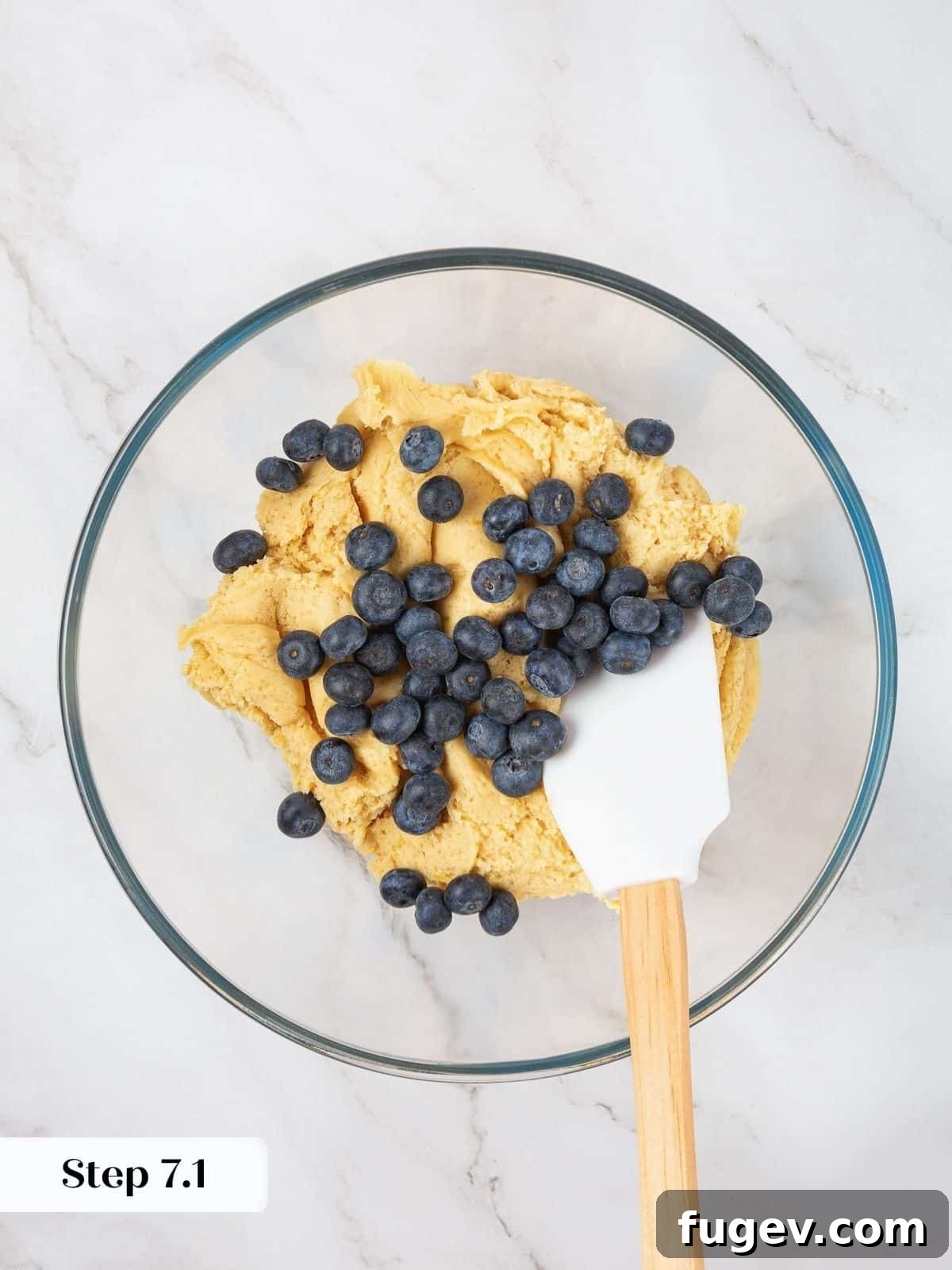 Bright Lemon Blueberry Delights 13 A bowl of vibrant lemon cookie dough with fresh blueberries resting on top, awaiting gentle folding.