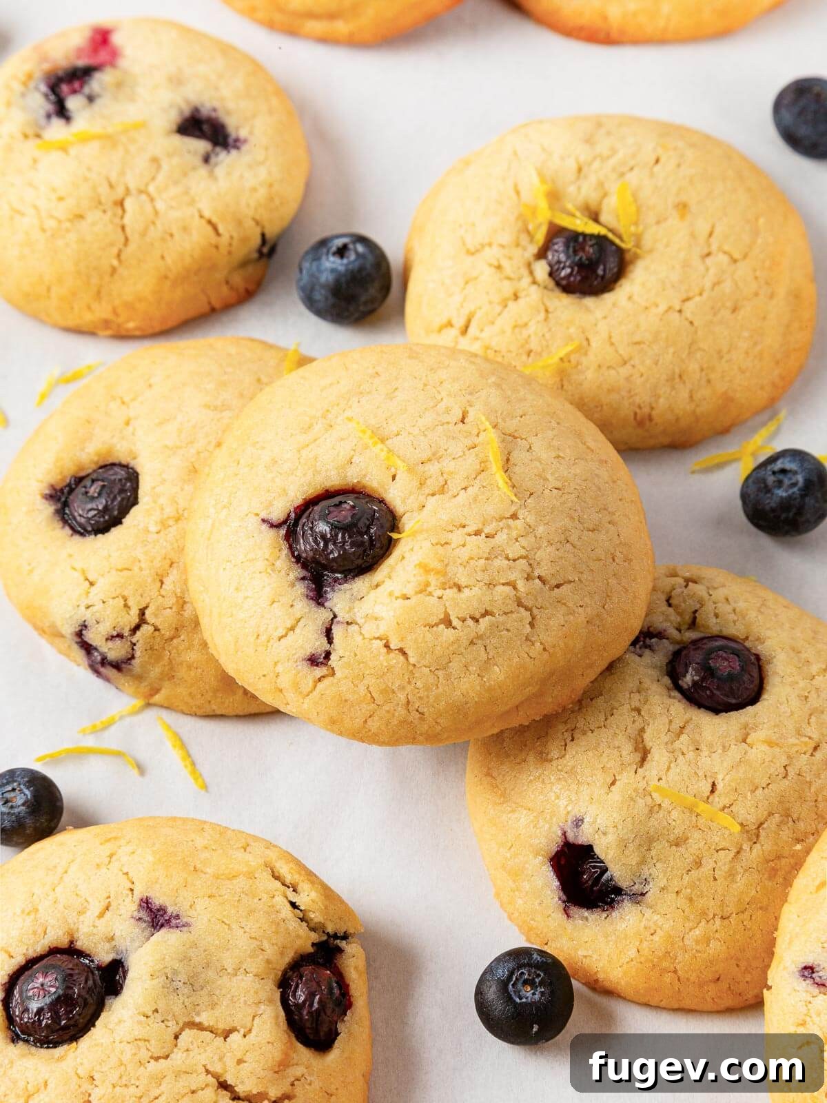 Bright Lemon Blueberry Delights 19 Several delightful lemon blueberry cookies beautifully displayed together on a kitchen countertop.