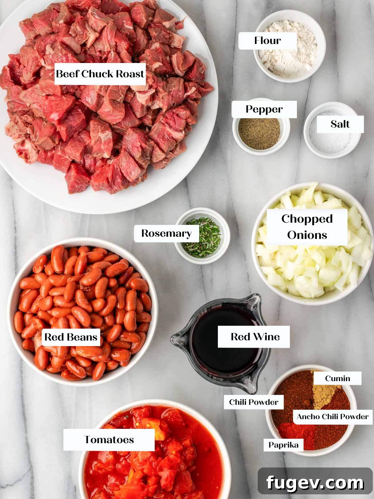 Hearty Steak Chili 4 Ingredients for steak chili laid out on a marble surface.