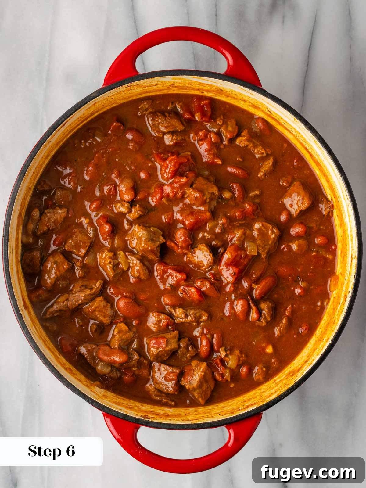 Hearty Steak Chili 9 Cooked chili simmering in a Dutch oven before serving.