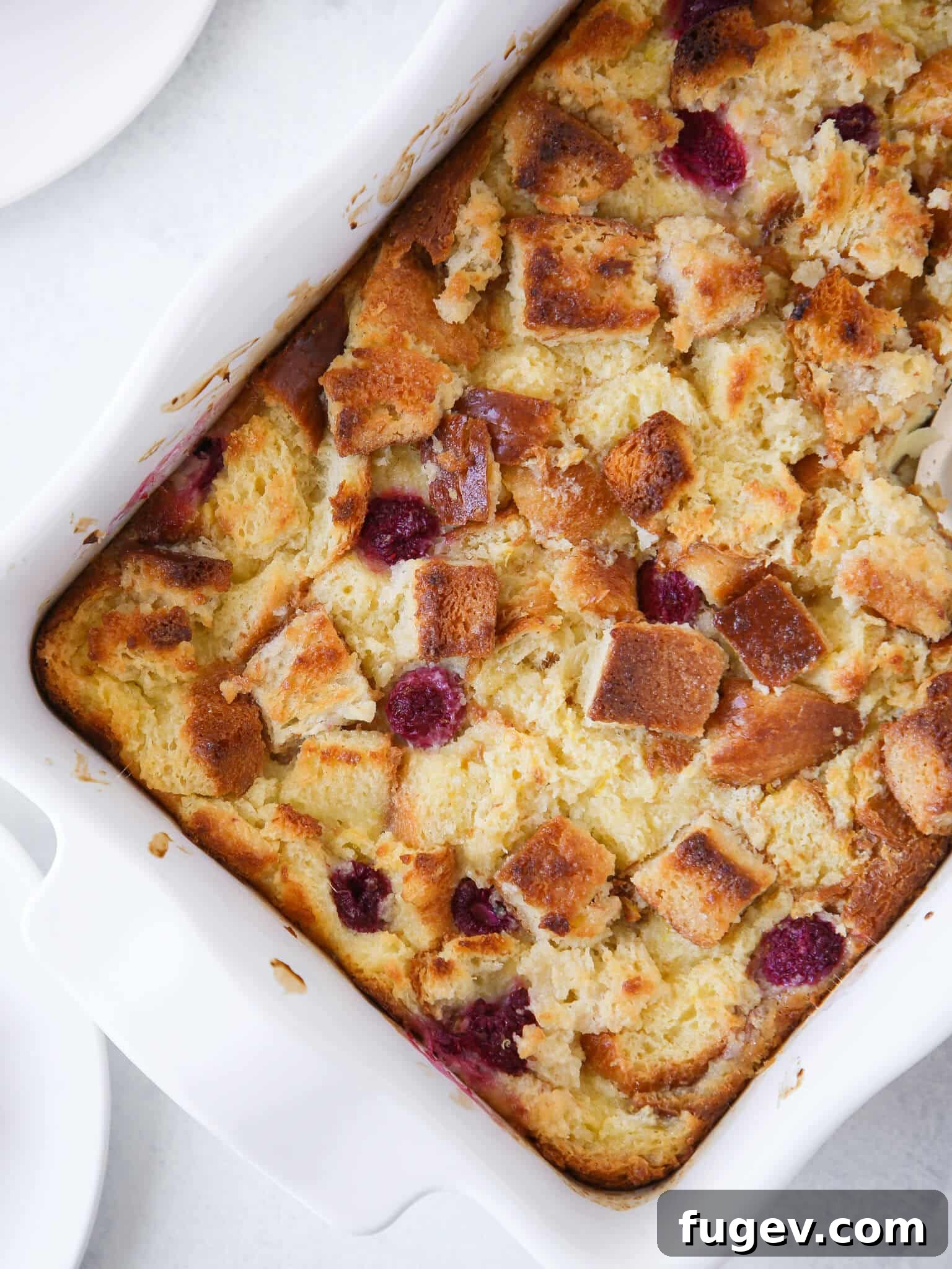 Zesty Lemon Bread Pudding 2 Lemon Raspberry Bread Pudding unsliced in white baking dish, ready to be served