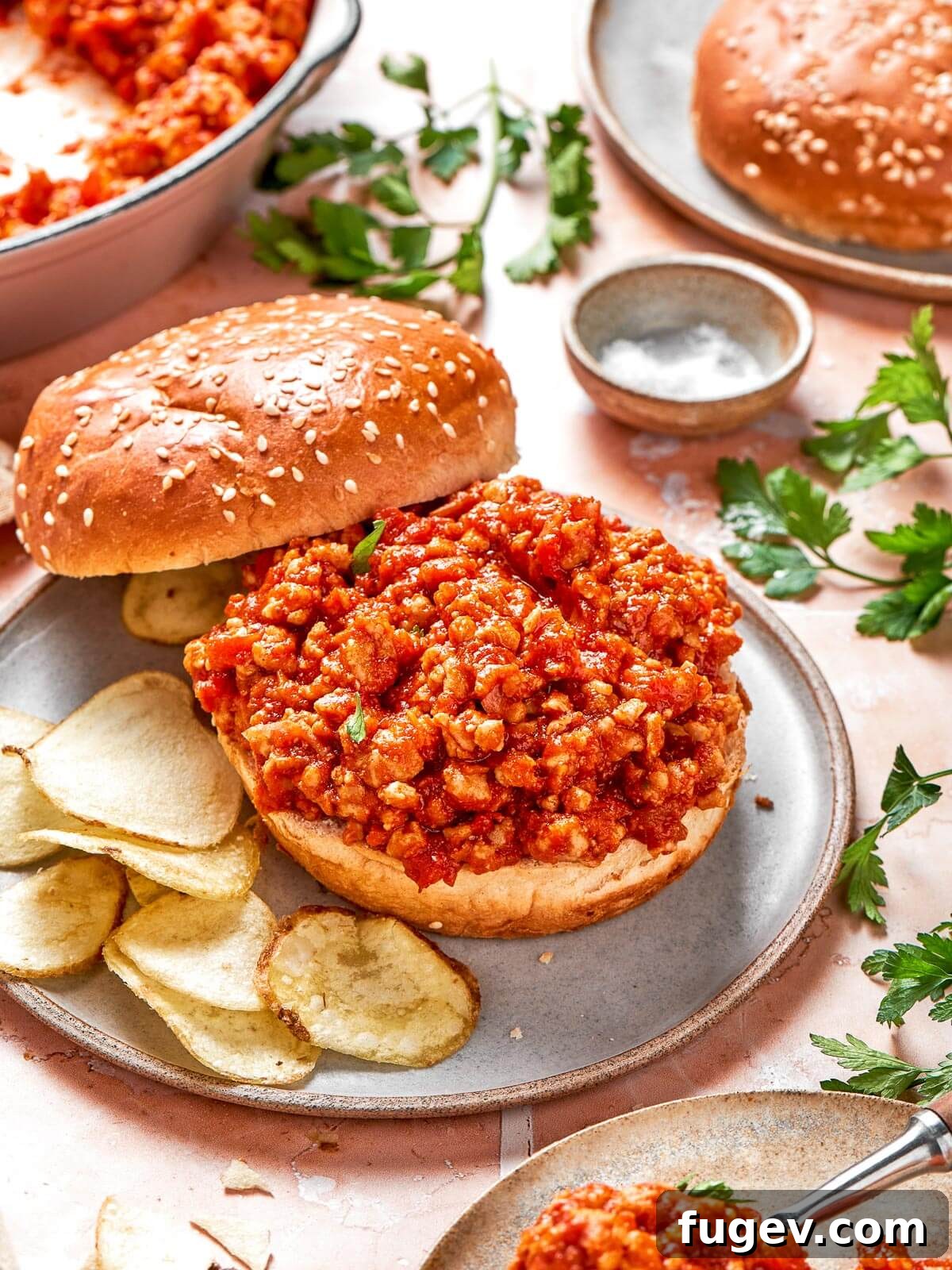 Homestyle Turkey Sloppy Joes 12 Hands serving up plates of turkey sloppy joes with buns to a waiting table.