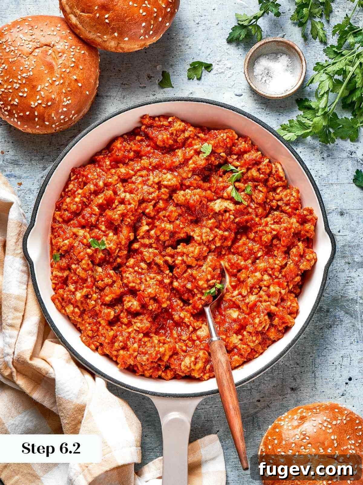 Homestyle Turkey Sloppy Joes 10 A sprinkle of fresh chopped herbs, likely parsley or chives, being added to the sloppy joe mixture just before serving.
