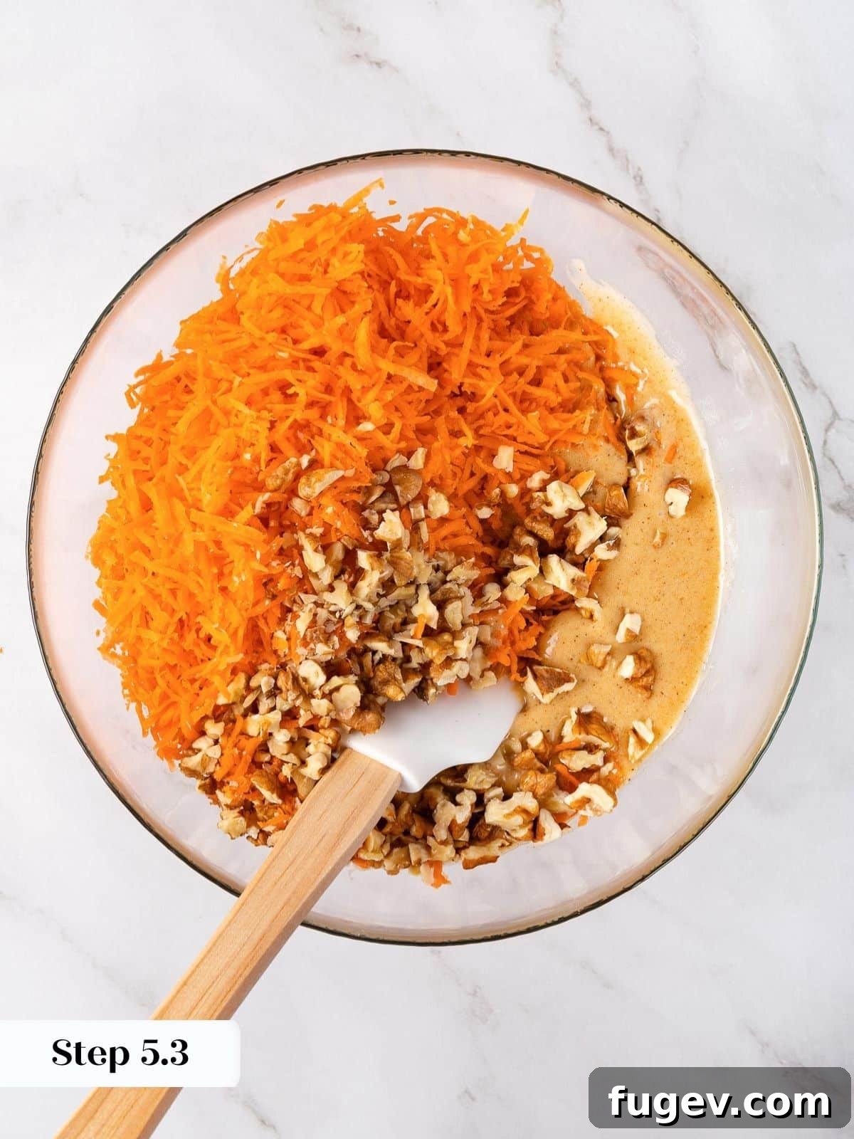 Decadent Carrot Cake Cupcakes 12 Adding shredded carrots to the batter.
