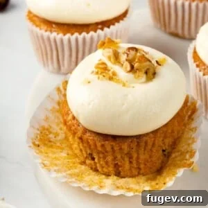 Decadent Carrot Cake Cupcakes 3 Cupcake liner peeled back to reveal tender carrot cake.