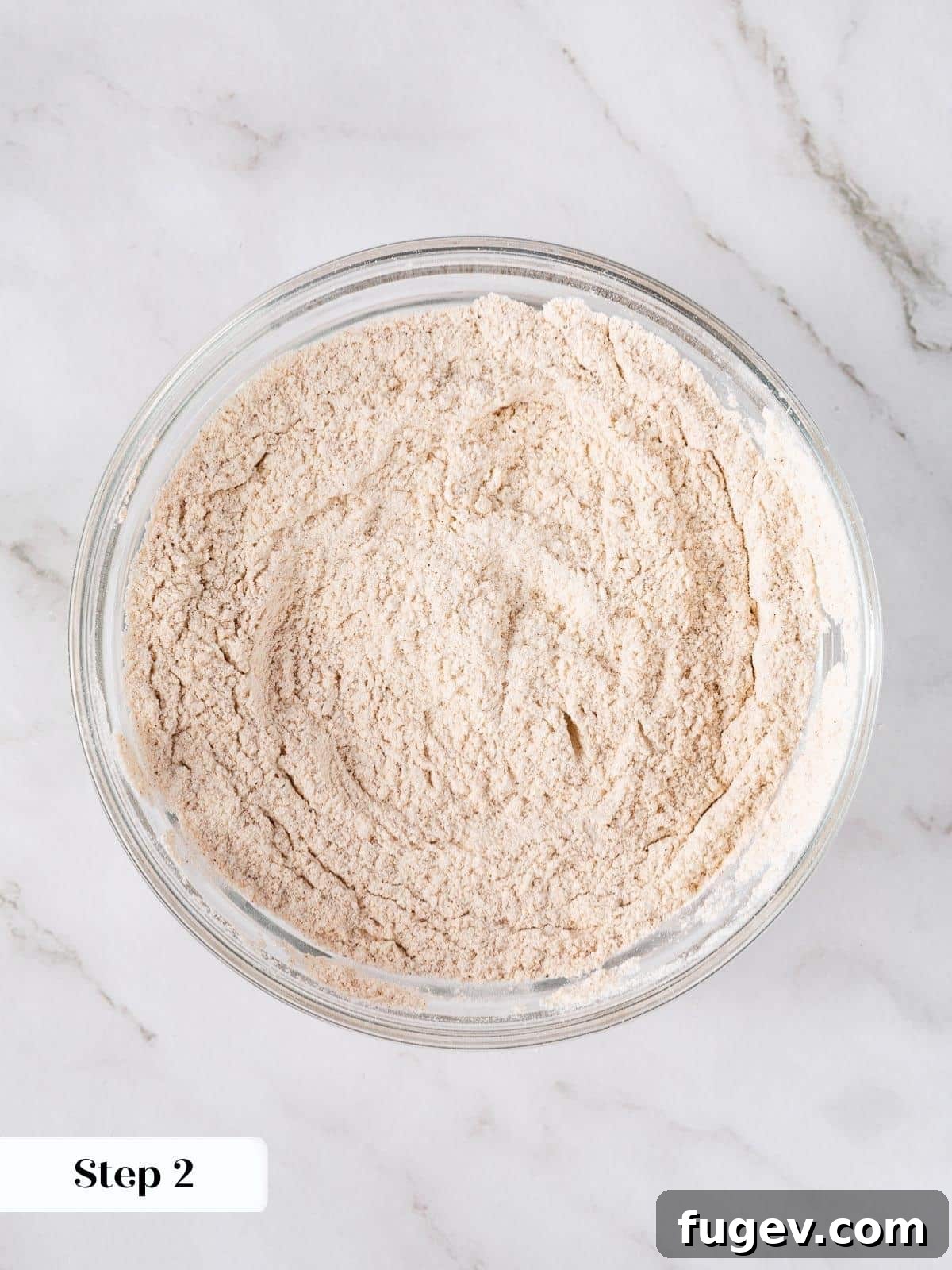 Decadent Carrot Cake Cupcakes 6 Dry ingredients like flour and spices whisked in a bowl.