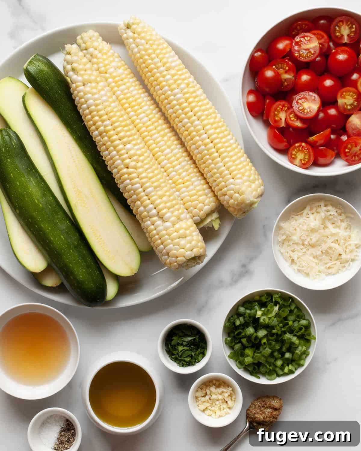 Summer Corn & Zucchini Medley 3 All fresh ingredients for the grilled zucchini corn salad laid out: zucchini, corn on the cob, cherry tomatoes, scallions, parsley, Parmesan cheese, olive oil, white wine vinegar, whole grain mustard, garlic, salt, and pepper.