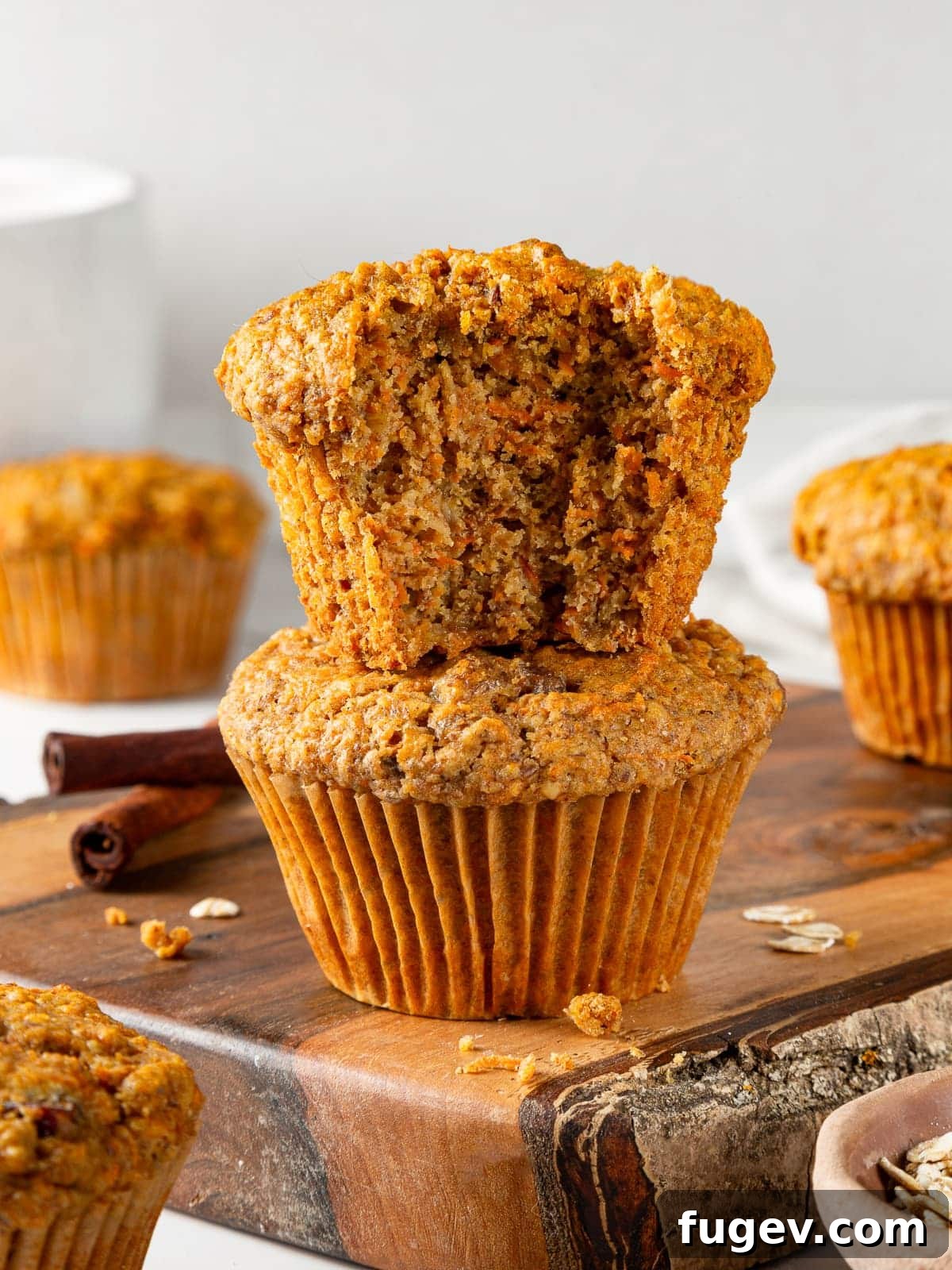 Wholesome Carrot Muffins 2 Partially eaten healthy carrot muffin revealing soft, moist center, packed with visible carrot shreds and oats.