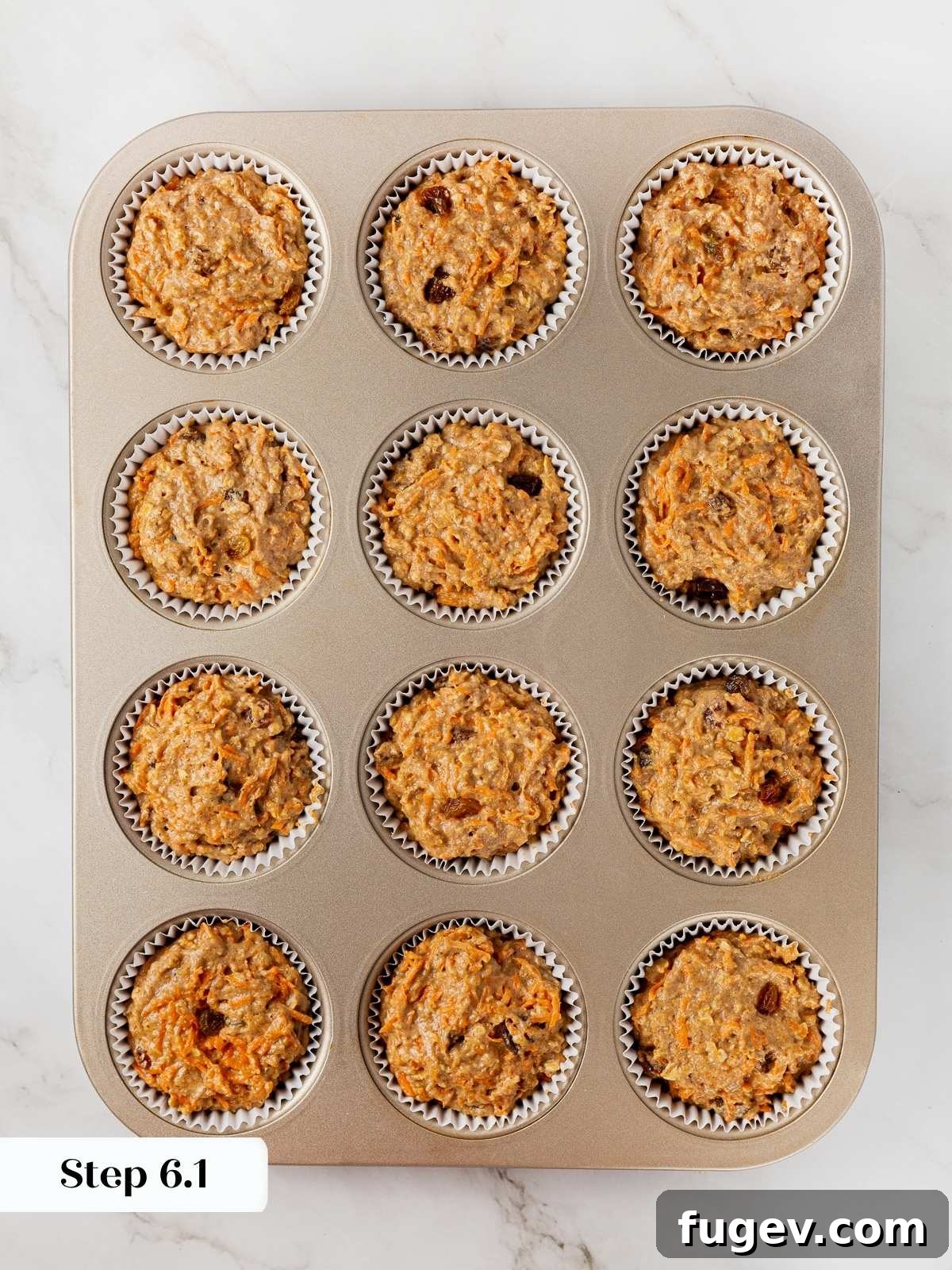 Wholesome Carrot Muffins 11 Healthy muffin batter carefully scooped into lined muffin cups, ready for baking.
